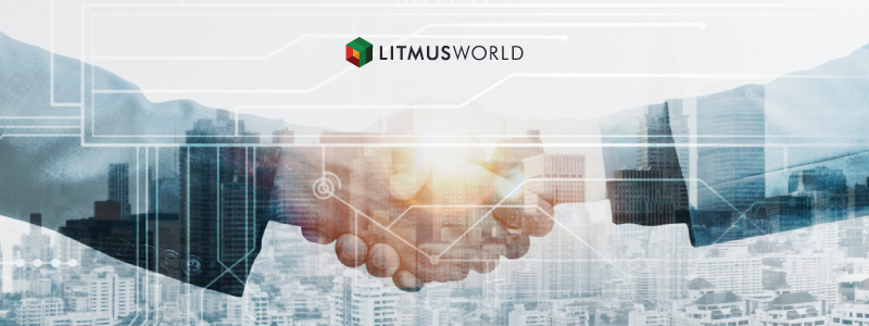 LitmusWorld | Image of hands shaking over a background of real estate
